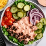 Easy Burger Bowl Recipe with Special Sauce – All the Flavor, None of the Bun! 2 Burger bowl with ground beef, lettuce, pickles, tomatoes, onions, and special sauce in a white bowl.