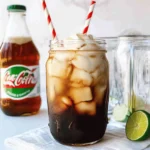 A Sweet Summer Throwback: Dirty Dr Pepper Recipe from My Grandmother's Porch 2 Dirty Dr Pepper mocktail with ice, cream, and striped straws in a mason jar