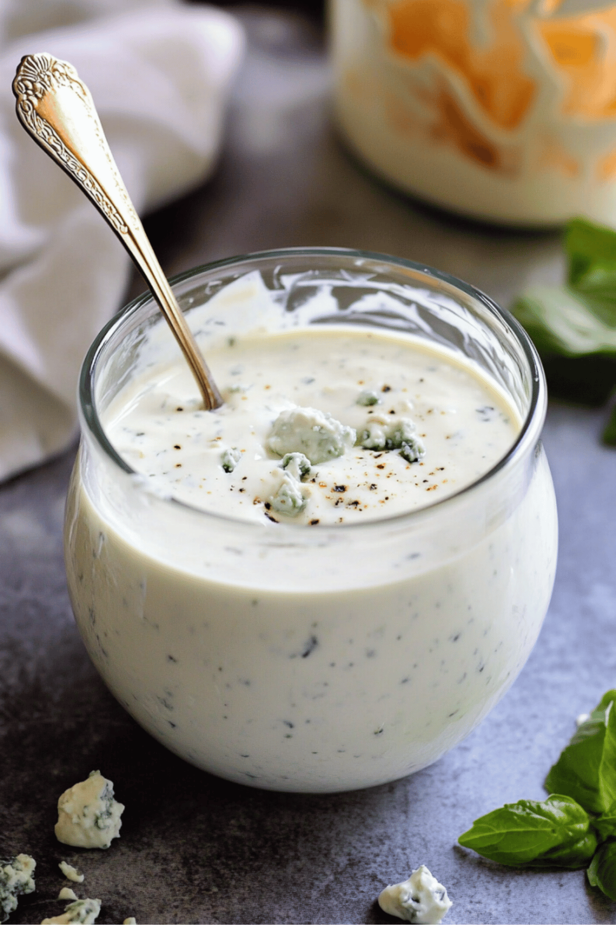 Creamy Blue Cheese Dressing with Fresh Herbs Blue cheese dressing with cracked pepper and crumbles in a rustic jar
