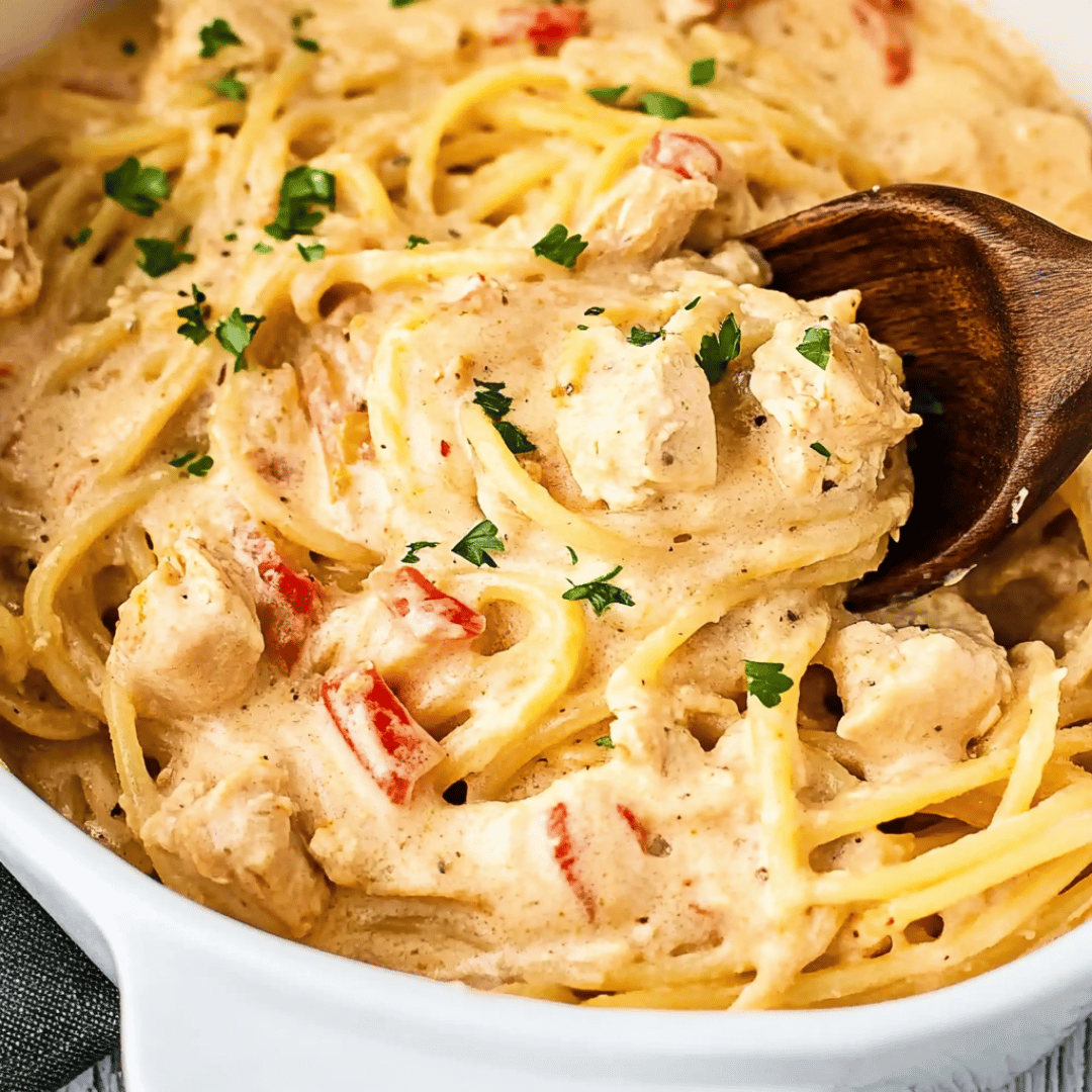Baked Chicken Spaghetti Casserole Fresh from the Oven Chicken spaghetti casserole being served from a white baking dish
