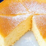 Fluffy cloud cake sliced and dusted with powdered sugar