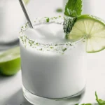 Coconut Mojito – The Ultimate Tropical Cocktail Recipe Guide 2 Coconut Mojito with lime wheel, mint sprig, and sugar-lime rim in a clear glass