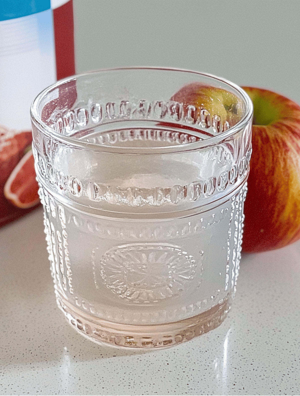 Pink Salt Recipe with ACV and Apple Pink salt recipe with apple cider vinegar and apple on counter