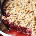 đ A Sweet Slice of Summer: Strawberry Rhubarb Crumble Recipe 2 Freshly baked strawberry rhubarb crumble with golden topping in a white baking dish