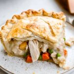 How To Make The Perfect Chicken Pot Pie – Step-by-Step Recipe + Tips 2 slice of homemade chicken pot pie with golden flaky crust