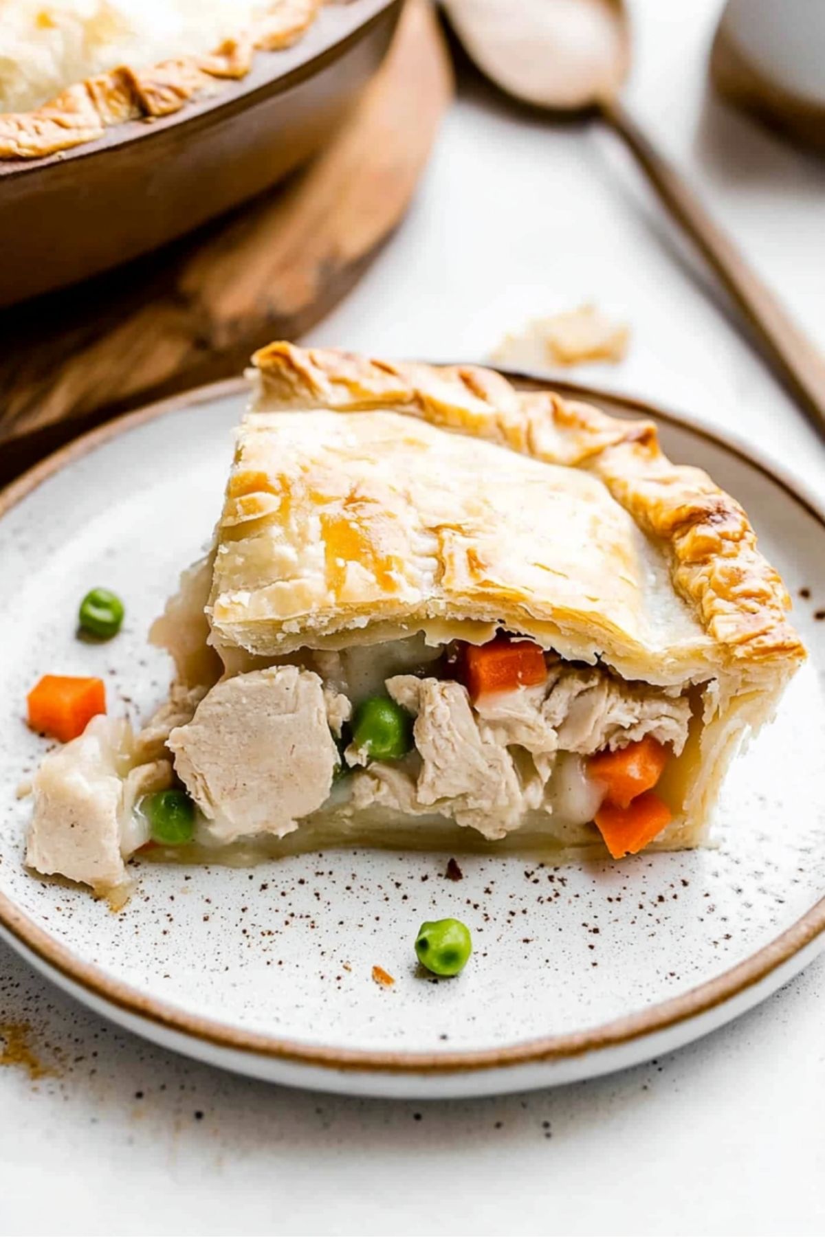 Rustic-style chicken pot pie slice with flaky layers creamy homemade chicken pot pie with thick crust