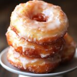The Best Ever Sour Cream Donut Recipe – Tender, Tangy & Glazed 2 Glazed sour cream donuts stacked on white plate